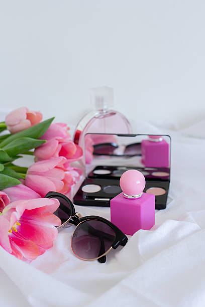 istock Pink tulips, eye shadow palette with mirror, sunglasses and perfume bottle on white background, women cosmetics set 2228775230