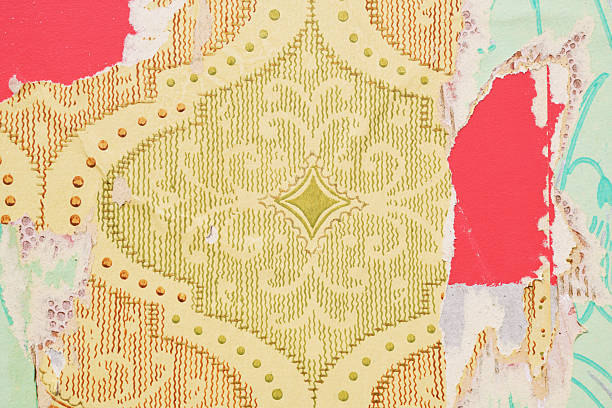 Old wallpaper on the wall. Old torn wallpaper for texture or background.