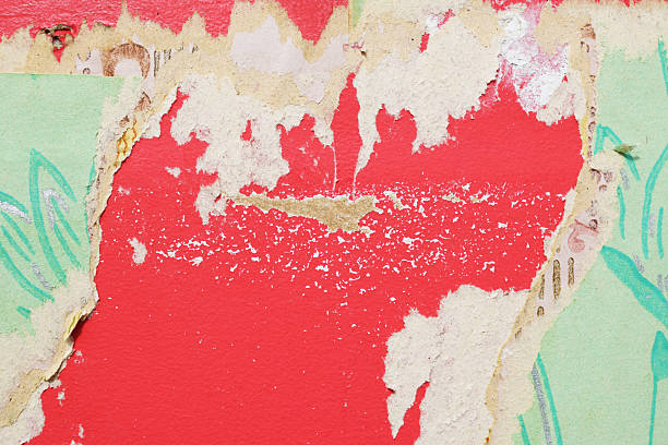 istock Old wallpaper on the wall. Old torn wallpaper for texture or background. 2228779065