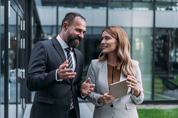 istock Business people using digital tablet outdoors. 2228780889