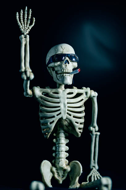 istock Smoking Halloween Skeleton Wearing Sunglasses and Waving 2228784007