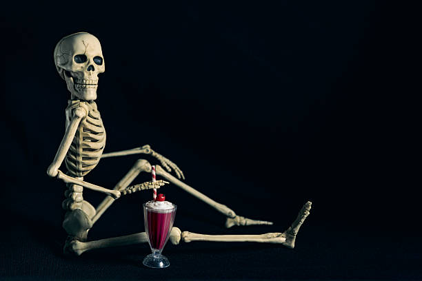 istock Funny Halloween Skeleton Sitting With Smoothie Milkshake 2228784078