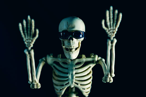 istock Skeleton in Sunglasses With Hands Up 2228784094