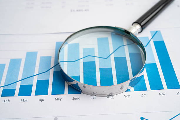 istock Magnifying glass on data business graphs paper. 2228784814