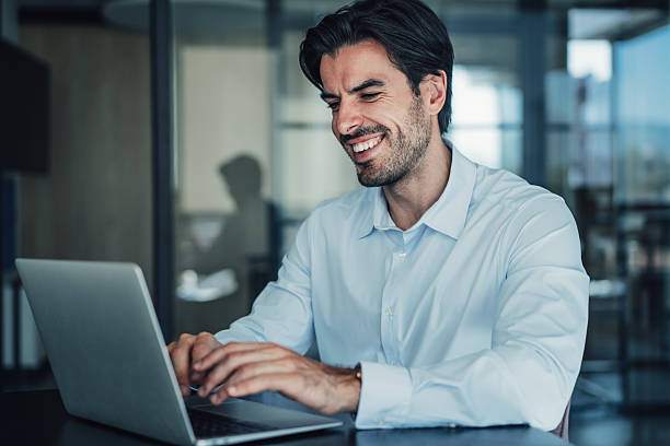 istock Successful businessman in modern office working on laptop. 2228787528