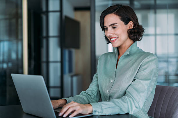 istock Successful businesswoman in modern office working on laptop. 2228787530