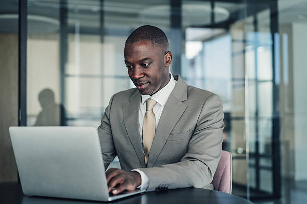 istock Successful businessman in modern office working on laptop. 2228787533