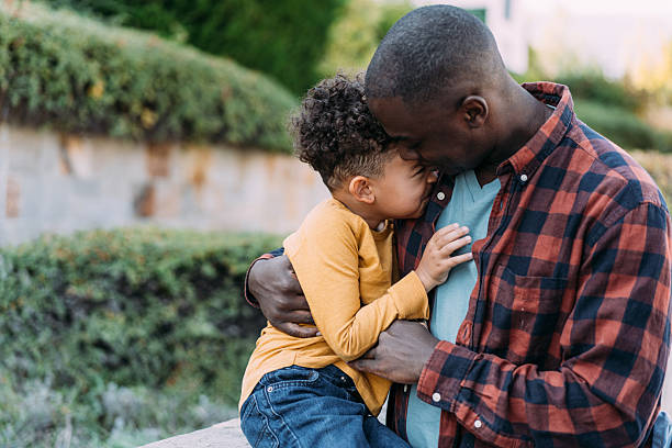 istock Father and son hugging each other while playing outdoors. 2228790132