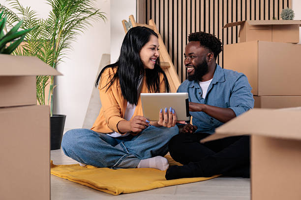 istock Smiling Couple Sets Up Internet in New Home 2228790531