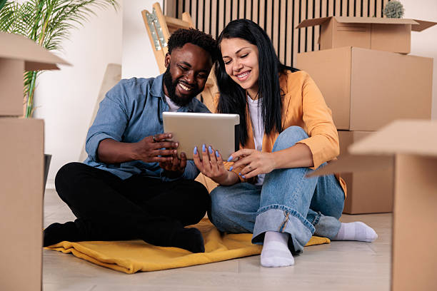 istock Smiling Couple Sets Up Internet in New Home 2228790579