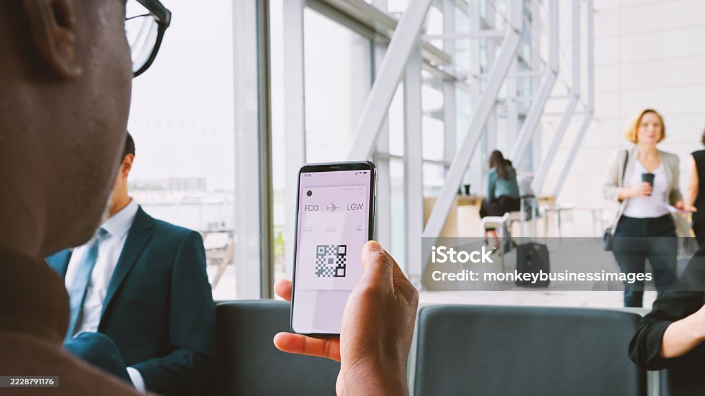 Male Passenger In Airport Departure Lounge Looking At Digital Boarding Pass On Smart Phone 35-39 Years Stock Photo Male Passenger In Airport Departure Lounge Looking At Digital Boarding Pass On Smart Phone 35-39 Years Stock Photo