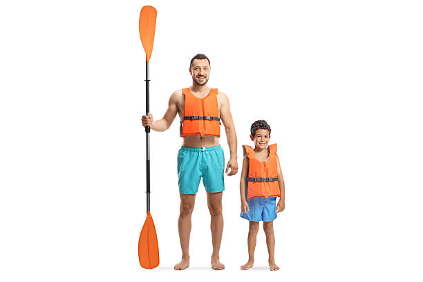 Father and son with a paddle wearing life jackets