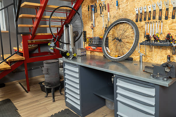 istock Bike workshop with metal workbench holding bicycle wheel tools hanging 2228794330