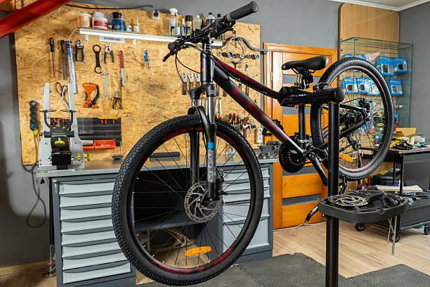 istock Black bike fixed for repair in organized maintenance space 2228794372