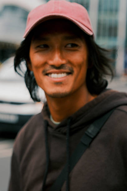 istock Smiling Young Asian Tech Executive on Phone Call in Modern City. 2228794835