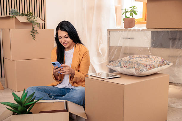 istock Woman Setting Up Internet in New Home Using Smartphone 2228794994
