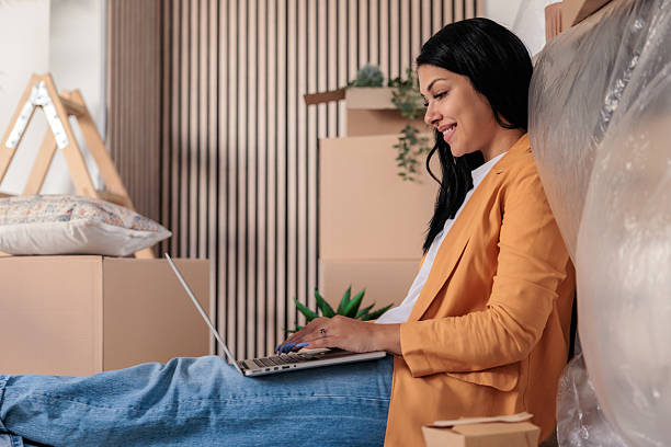 istock Woman Setting Up Internet in New Home Using Laptop 2228795157
