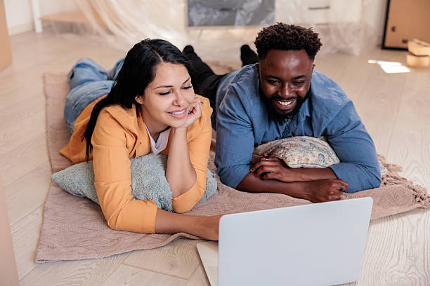 istock Happy Couple Relaxing on Floor While Setting Up Internet in New Home 2228796106