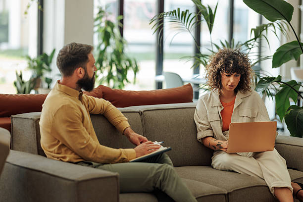 istock Coworkers discussing a project using a laptop and taking notes in modern office space 2228796390