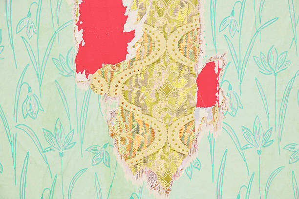 Old wallpaper on the wall. Old torn wallpaper for texture or background.