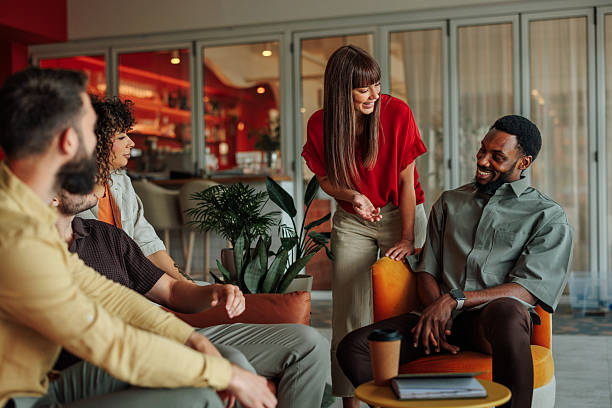 istock Coworkers chatting during a break in the office lounge area 2228796869