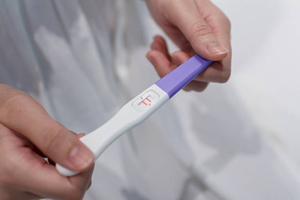 istock Hand holding the pregnancy test is showing a positive result. 2228797531