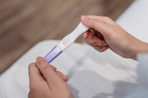 istock Hand holding the pregnancy test is showing a positive result. 2228797533