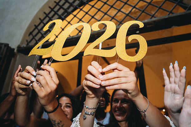 istock Students celebrating graduation holding 2026 sign 2228798556