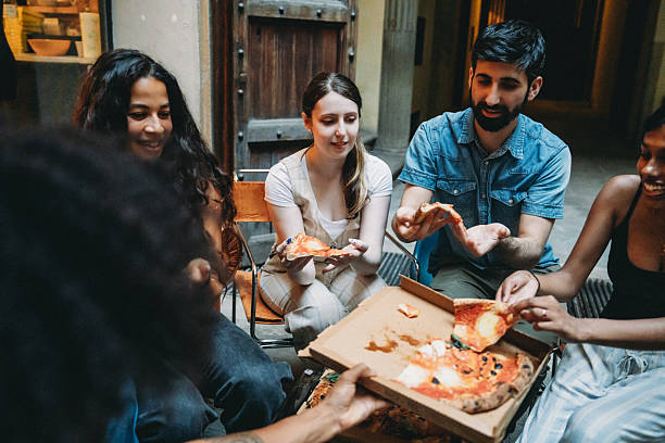 istock Group of friends eating pizza outdoors in Florence 2228799097