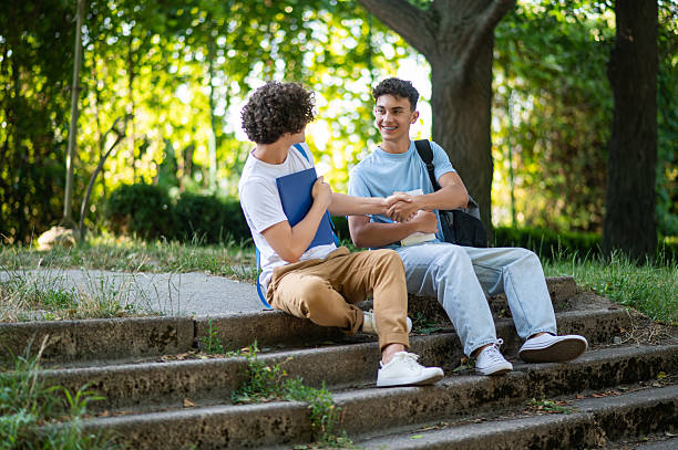istock Two friends spending time together in the park after school 2228801568