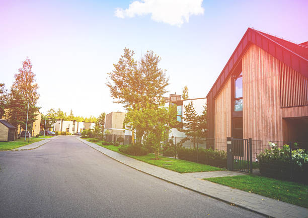 istock Road in gated community with Modern Barn House 2228801606