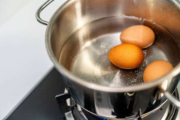 istock Boiled eggs in a pot. Chicken eggs boiling in saucepan on gas stove 2228802044