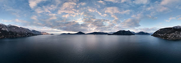 istock Panoramic View of Tranquil Lake Surrounded by Snowy Mountains at Sunset 2228802218