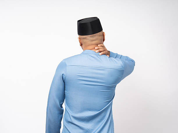 istock Asian muslim man has problem with structural back posture He had neck and shoulder pain. Islamic man Massaged neck and shoulders for relief reduce muscle tension. 2228803721