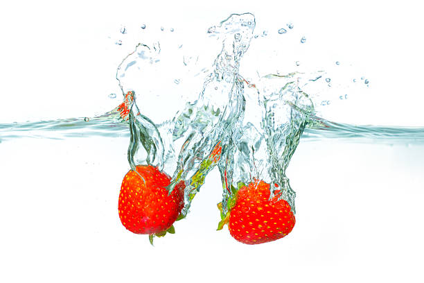 istock Fresh Strawberries Splashing Into Clear Water Creating Vibrant Bubbles 2228803995