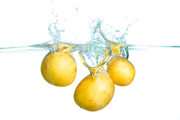 istock Fresh Potatoes Splashing Into Clear Water Creating Ripples 2228804000