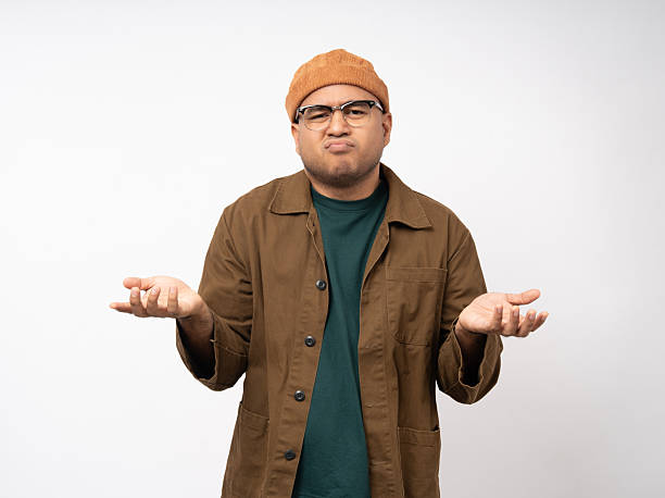 istock Handsome asian young man standing bored serious thinking on isolated white background. Portrait of serious depressed senior asian man looking at camera. People with problem in life 2228804013