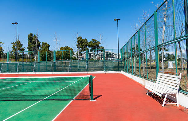 Outdoor empty tennis court with blue sky