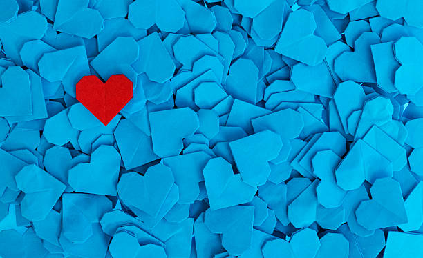 istock Blue origami paper hearts with a red one 2228805598