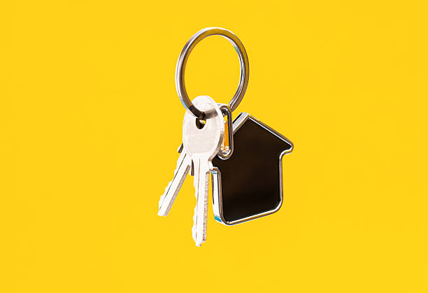 istock House shaped with a key on yellow background 2228805798