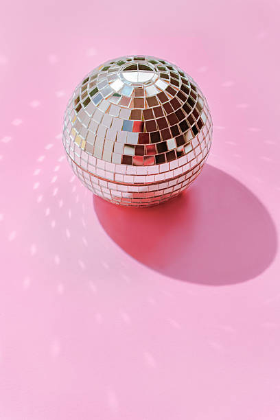 istock Disco Ball Reflecting Light on Pink Background 2228806760