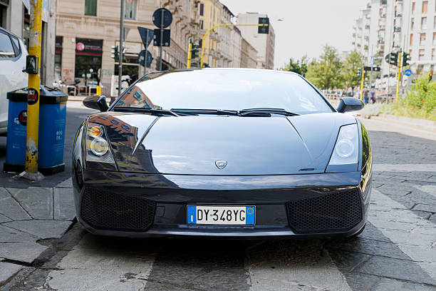 A red colored Lamborghini Huracan is parked in central London England UK on a cloudy day.