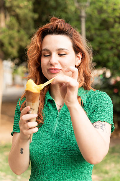 Woman enjoying a mango ice cream outdoors