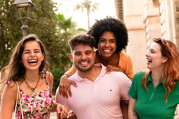 istock Four friends piggybacking and laughing together 2228812688