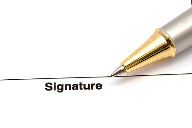 A pen is poised above the word \