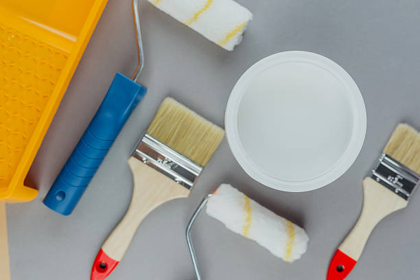 istock Top view of painting tools including brushes and rollers with white paint for home renovation and DIY concept 2228815253