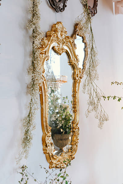 istock Elegant decorative mirror hangs on a wall adorned with greenery 2228816037