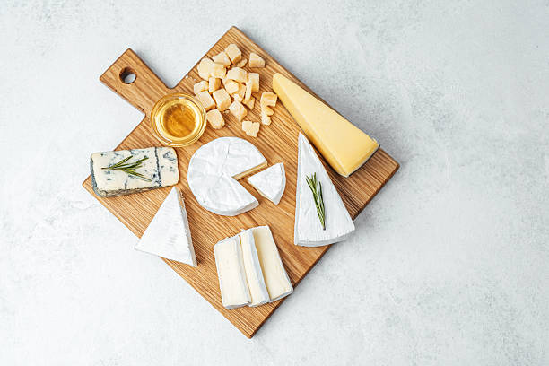 istock Cheese platter featuring various types of cheeses on a wooden board 2228816330