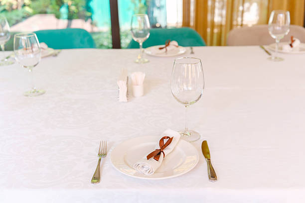 Dinner in the evening. Restaurant table set with glasses in bokeh style