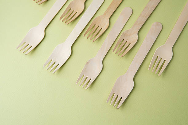 istock Wooden disposable forks  on pastel green background 2228817106